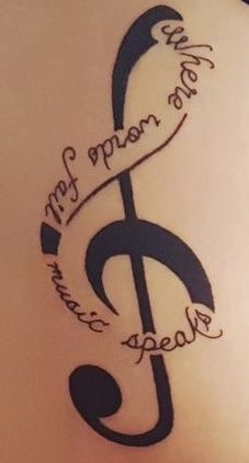 a tattoo with a treble on it that says, my mom is the music note