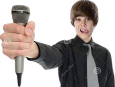 a young man holding a microphone in his right hand and pointing it at the camera