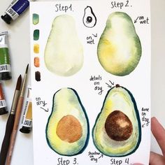 an avocado cut in half and painted with watercolors