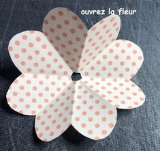 a paper flower with polka dots on it