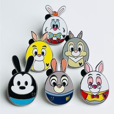 several cartoon characters are depicted in the shape of pinback buttons and lapel backs