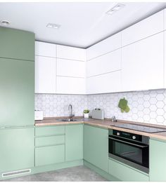 a kitchen with green cabinets and white walls