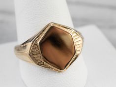 This vintage signet ring is unique, yet timeless! The elongated hexagonal face is polished smooth and ready to engrave with the monogram of your choice. The shoulders are structured and accented with neat grooves that catch the light and draw the eye. Market Square Jewelers works with one of the finest hand engravers in the northeast. With over 30 years of experience, our engraver hand carves lettering, monograms, crests, or patterns in period-specific styles. Choose from our many monogram options shown in the listing or contact us directly with your own crest, monogram, or for additional information, and pricing! Metal: 14K Yellow Gold Top Measurements: 15 x 12 mm, Hexagon Ring Size: 12.25 Marks: "14K" Stamped on the inside band Signet Ring Gold, Market Square, Gold Statement Ring, Personalized Ring, Pocket Watch Chain, Cameo Ring, Gold Signet Ring, Right Hand Rings, Watch Chain