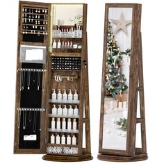 an open wooden jewelry case next to a mirror with christmas decorations on it and a tree in the background