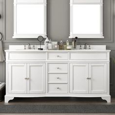 a white double sink vanity with mirrors above it