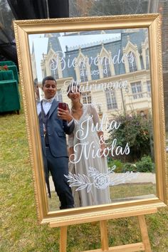 a man and woman are standing in front of a sign that says, bride and groom