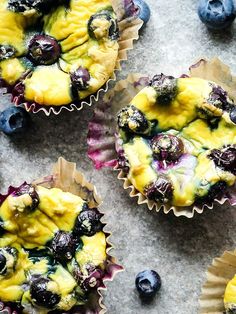 four blueberry muffins sitting on top of a table