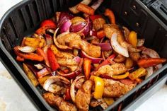 chicken, onions and peppers in a black container