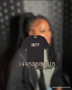 a woman holding up a t - shirt with the number 17 on it in front of her