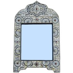 an ornate mirror is shown against a white background