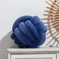 a blue pillow sitting on top of a white table