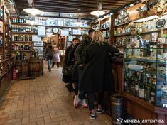 people are standing in line at the liquor store for drinks and beverages to be sold