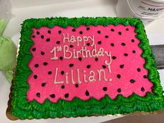 a birthday cake is decorated with green and pink frosting that says, happy 1st birthday lilian