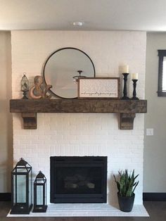 a living room with a fire place, mirror and potted plant on the mantel