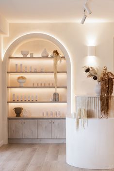 the interior of a store with shelves and vases