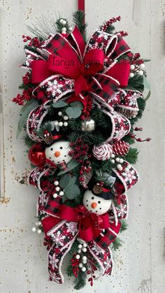 a christmas wreath hanging on the side of a door