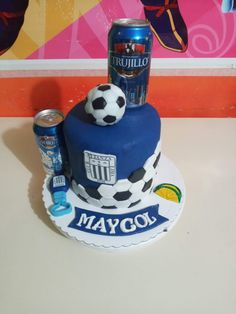 a birthday cake with a soccer theme on it and a can of beer next to it