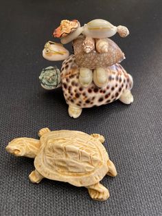 two small turtle figurines sitting on top of each other