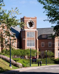 a large building with a clock on the side of it's face and windows