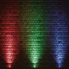 a brick wall with multicolored lights on it