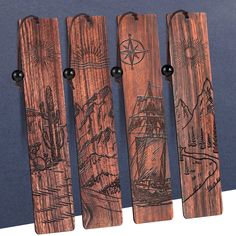 four wooden bookmarks with drawings on them