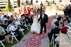 a bride and groom walking down the aisle after their wedding ceremony in las vegas, nv