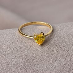 Yellow topaz is believed to bring joy, abundance and health. We crowned the heart symbol, which is a symbol of love, friendship and many other affections, with precious stones. Now you can see the love at your finger. Other Products Compatible with Our Yellow Topaz Heart Ring: https://artdiamonds.etsy.com/listing/1391167870/yellow-topaz-heart-necklace14k-solid?utm_source=Copy&utm_medium=ListingManager&utm_campaign=Share&utm_term=so.lmsm&share_time=1694013680759 F E A T U R E S * Made to Order. * Gold KT: 14K * Gold Color: Yellow Gold, Rose Gold, White Gold * Yellow Topaz Carat: 1.00 ct. * Stone Height: 7,12 mm / 0.28 inch * Stone Width: 6,12 mm / 0.24 inch * Setting Type: Bezel Setting * Ready to Ship in 1-3 Business Days * 100% US sourced * 2 Years Warranty * Free Express International Sh Yellow Topaz Ring, November Birthstone Jewelry, Heart Symbol, November Birthstone, Solid Gold Rings, Lovely Jewellery, Topaz Ring, Birthstone Jewelry, Mother Day Gifts