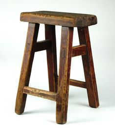 an old wooden stool on a white background