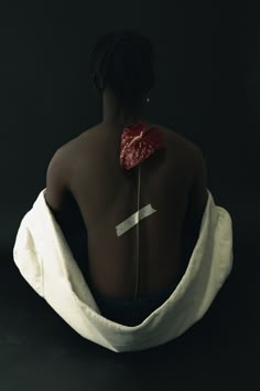 the back of a woman's body with a flower on it