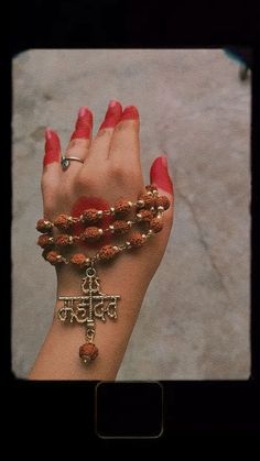 a woman's hand with bracelets and rings on it