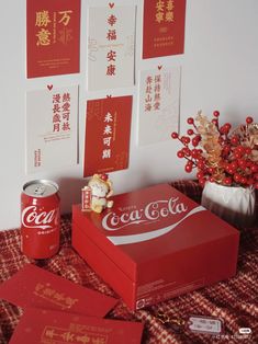 a coca - cola box and some cards on a table