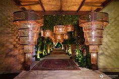 an outdoor area with lots of lights hanging from the ceiling and plants growing on the walls