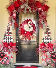 the front door is decorated for valentine's day with red, black and white decorations