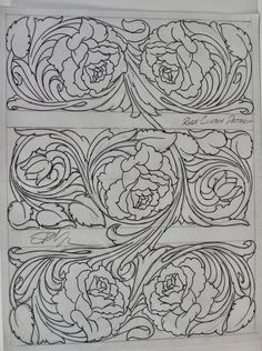 an intricately designed panel with flowers and swirls on the sides, in black ink