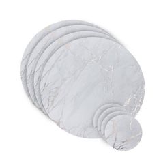 six white marble coasters stacked on top of each other in front of a white background