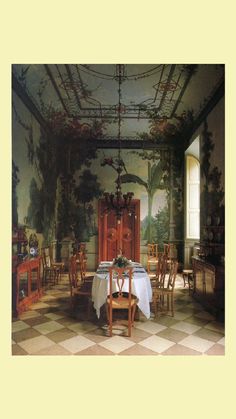 a dining room with a table and chairs in front of a painting on the wall