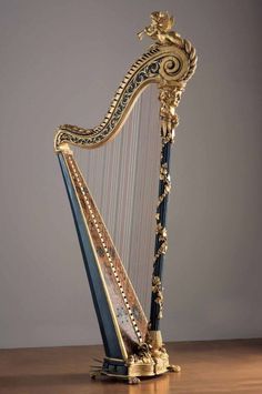 an ornate harp sitting on top of a wooden table