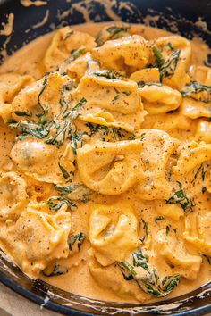 a bowl filled with pasta and sauce on top of a table