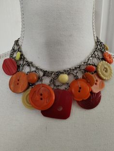 a close up of a necklace with buttons on it