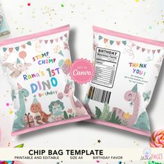 two pink and white bags with dinosaurs on them, next to a candy bar wrapper