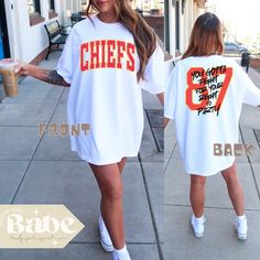 🏈 Get Game Day Ready with this Kelce Chiefs inspired tee! 🏈 Front CHIEFS is purposely DISTRESSED - option for non distressed available. SIZING: Follow the size chart in the photos to determine fit for a regular or an oversized look! DETAILS: Both Front & Back Design - Message me for a custom request :) Comfort Colors will be your new favorite tee!! If you're looking for a thick, structured tee that's also super soft and breathable--look no further! This garment-dyed heavyweight t-shirt ticks a Chiefs Game Day Outfit Fall, Chiefs Football Game Outfit, Cute Chiefs Game Outfit, Football Season Streetwear Tops With Text Print, Streetwear Tops With Text Print For Football Season, White Fan Merchandise Top With Back Print, Kansas City Chiefs Game Day Outfit, Chiefs Outfit Woman, Kansas City Chiefs Outfit