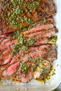 sliced steak with herbs and seasoning on top