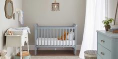 a baby's room with a crib, dresser and teddy bear in it