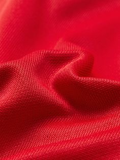 the red fabric is very soft and has been folded up to show it's texture