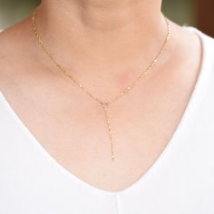 "14k Gold Y Necklace. 14K sparkle chain necklace. 14k delicate y necklace. This necklace is beautiful and delicate. The necklace will arrive in a gift box, ready for delivery. 14K gold necklace 14K gold drop chain (The picture in the listing is 2\") All components are 14k gold Please read our policies before you place your order. https://www.etsy.com/shop/SashJewelry/policy?ref=shopinfo_policies_leftnav To see other bracelets click here https://www.etsy.com/shop/SashJewelry?section_id=12354075&a 14k Gold Filled Lariat Necklace For Gift, Dainty 14k Gold-filled Lariat Necklace For Everyday, Dainty 14k Gold Long Drop Necklaces, Fine Jewelry Yellow Gold Backdrop Necklace With Delicate Chain, Dainty Long Drop 14k Gold Necklace, Dainty 14k Gold Long Drop Necklace, 14k Gold Lariat Chain Necklace As Gift, 14k Gold Long Drop Lariat Necklace Gift, 14k Gold Lariat Clavicle Chain Necklace