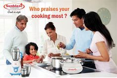 a group of people standing around a table with pots and pans