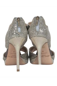 Embrace the epitome of glamour and beauty with these Jimmy Choo champagne gold heels, featuring an open-toe design, pair these heels with a sleek midi dress and a bold clutch for a modern evening look, or add a touch of sparkle to your daytime outfit with a cropped trousers and silk blouse. Size 8 (IT 38) Made in Italy Glitter fabric Leather sole & insole with minimal wear Exposed back zipper closure Gold-toned hardware Platform height 0.7” Heel height 4.7” Formal 4-inch Heels For Party Season, Chic Sparkling Ankle Strap Heels, Party Heels With Branded Heel Counter And Round Toe, Chic Holiday Heels With 4-inch Heel, Almond Toe Heels With Branded Heel Counter For Party, Party Heels With Branded Heel Counter And Almond Toe, Chic Open Heel Party Heels, Open Toe Heels For Gala And Party Season, Chic 4-inch Heels For Holiday