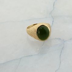 "10K YG Nephrite Jade Ring, Circa 1970, florentine finish to top, polished shank, 5/8\" across, high dome cabochon translucent stone. Size10, 6.6 Grams Stock # R00582A" Luxury Green Domed Ring, Green Cabochon Dome Ring For Formal Occasions, Green Oval Cabochon Dome Ring, Green Domed Jewelry With Polished Finish, Green Oval Cabochon Signet Ring For Formal Occasions, Formal Green Oval Cabochon Signet Ring, Classic Green Cabochon Signet Ring, Green Oval Dome Ring With Polished Finish, Gold Coin Ring