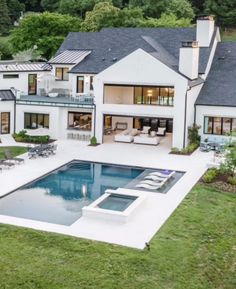 an aerial view of a house with a swimming pool and lounge chairs in the yard