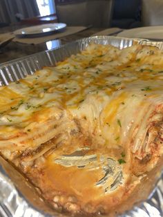 a casserole dish with meat and cheese on it sitting in a pan, ready to be eaten